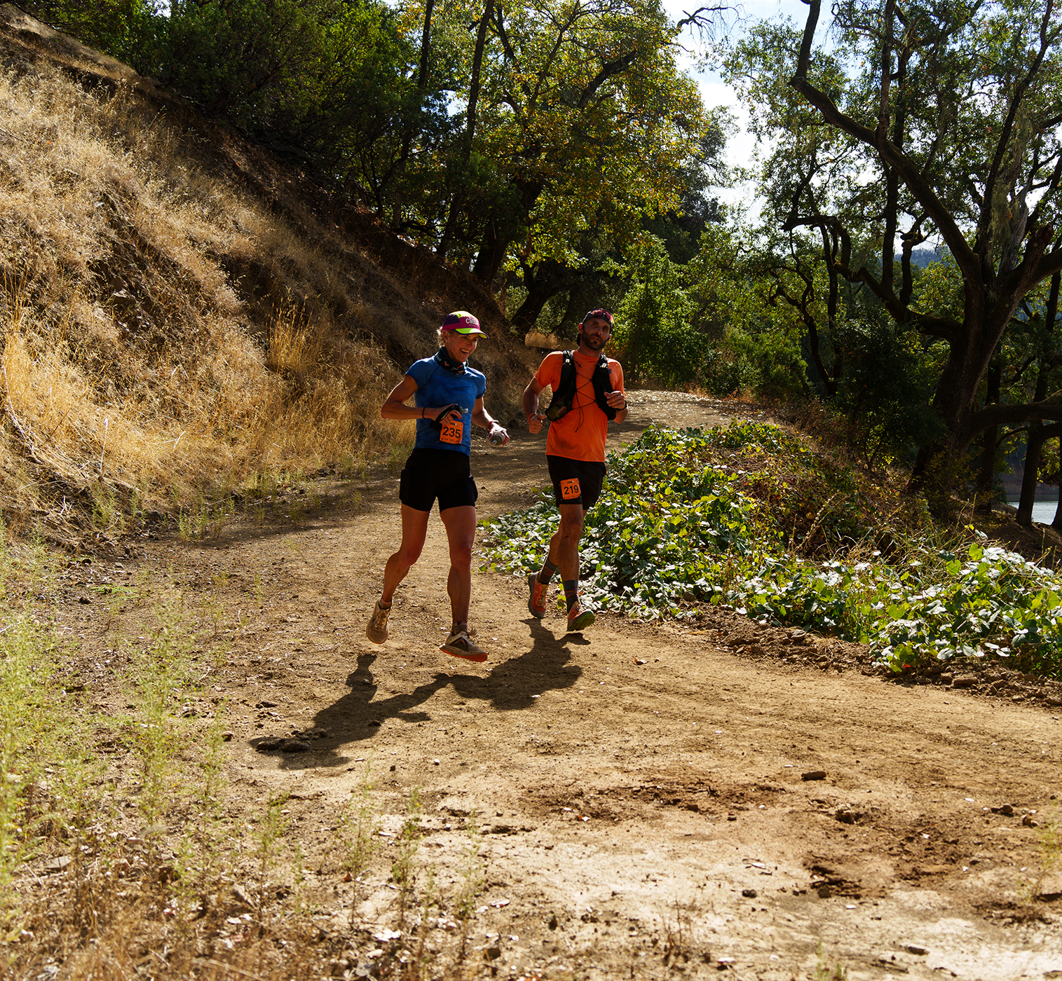 Two women running close to each other at Lake Sonoma